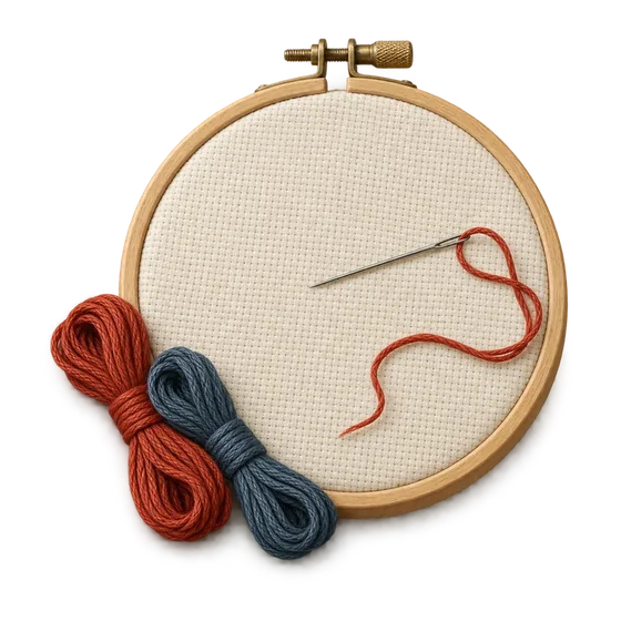 Aida cloth in a wooden hoop with a threaded needle and skeins of red and blue floss.